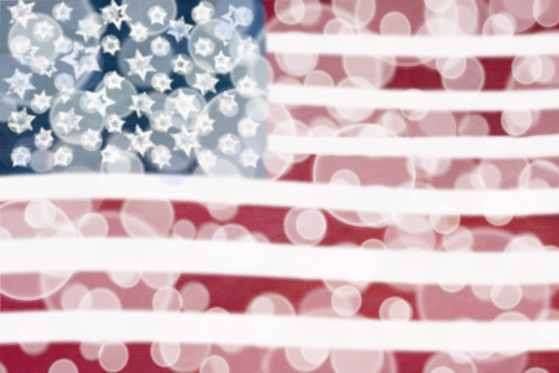 American flag with bokeh light effects creating a soft-focus, abstract patriotic background, representing the political divide and contested perceptions surrounding the 2020 US presidential election